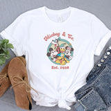 a mickey mouse and friends t - shirt next to a pair of jeans