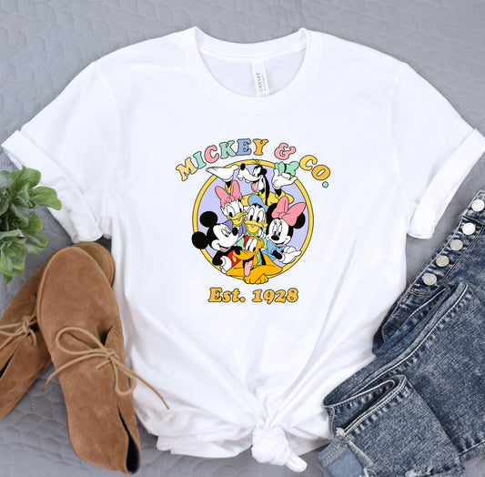 a white shirt with mickey mouse and friends on it