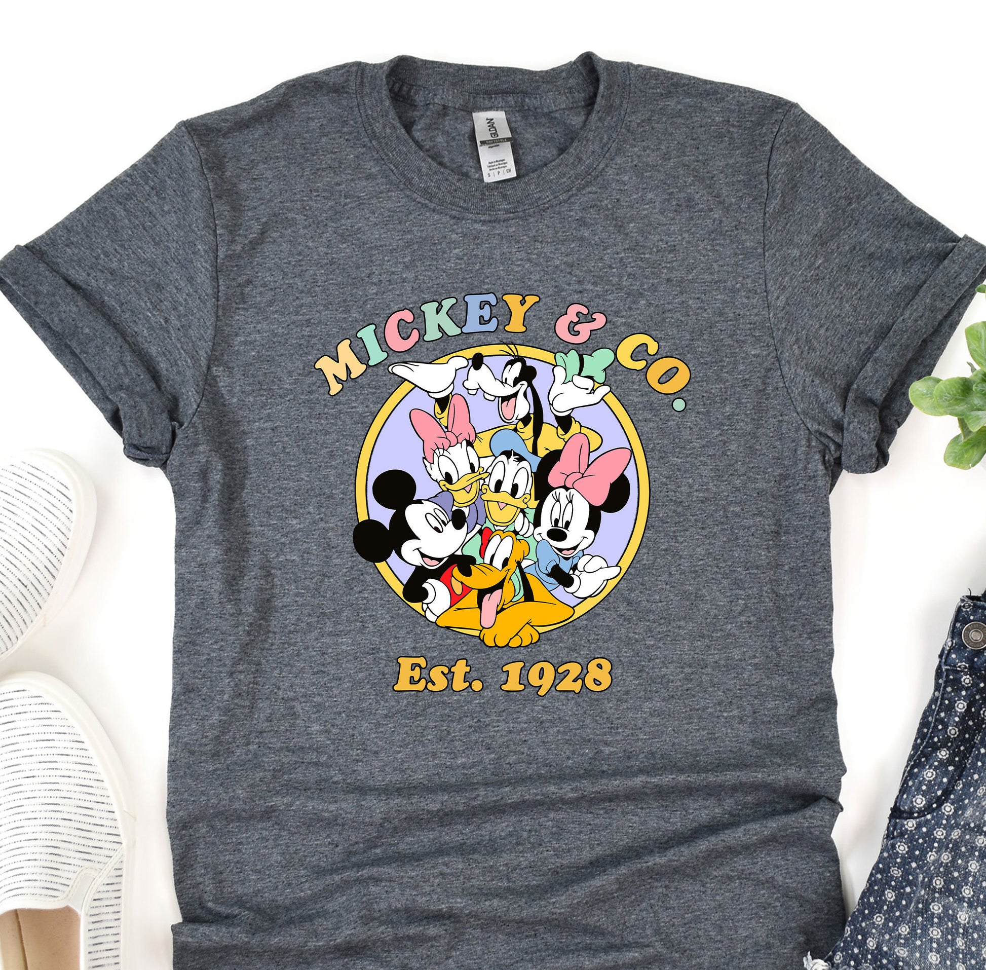 a mickey mouse t - shirt sitting on top of a table