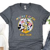 a mickey mouse t - shirt sitting on top of a table