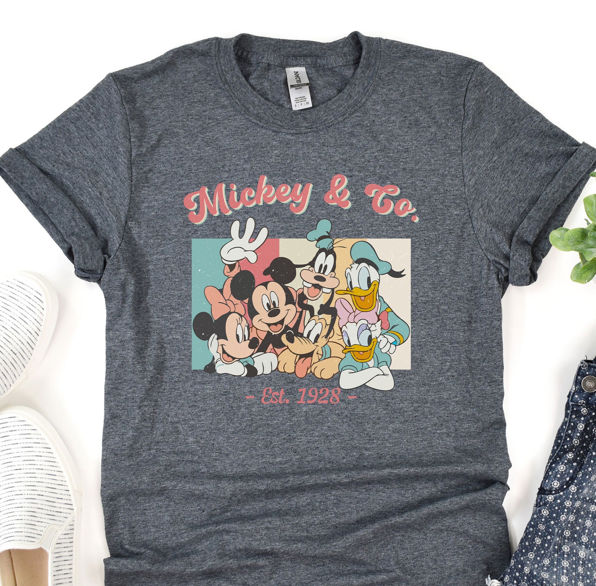 a mickey mouse t - shirt sitting on top of a table