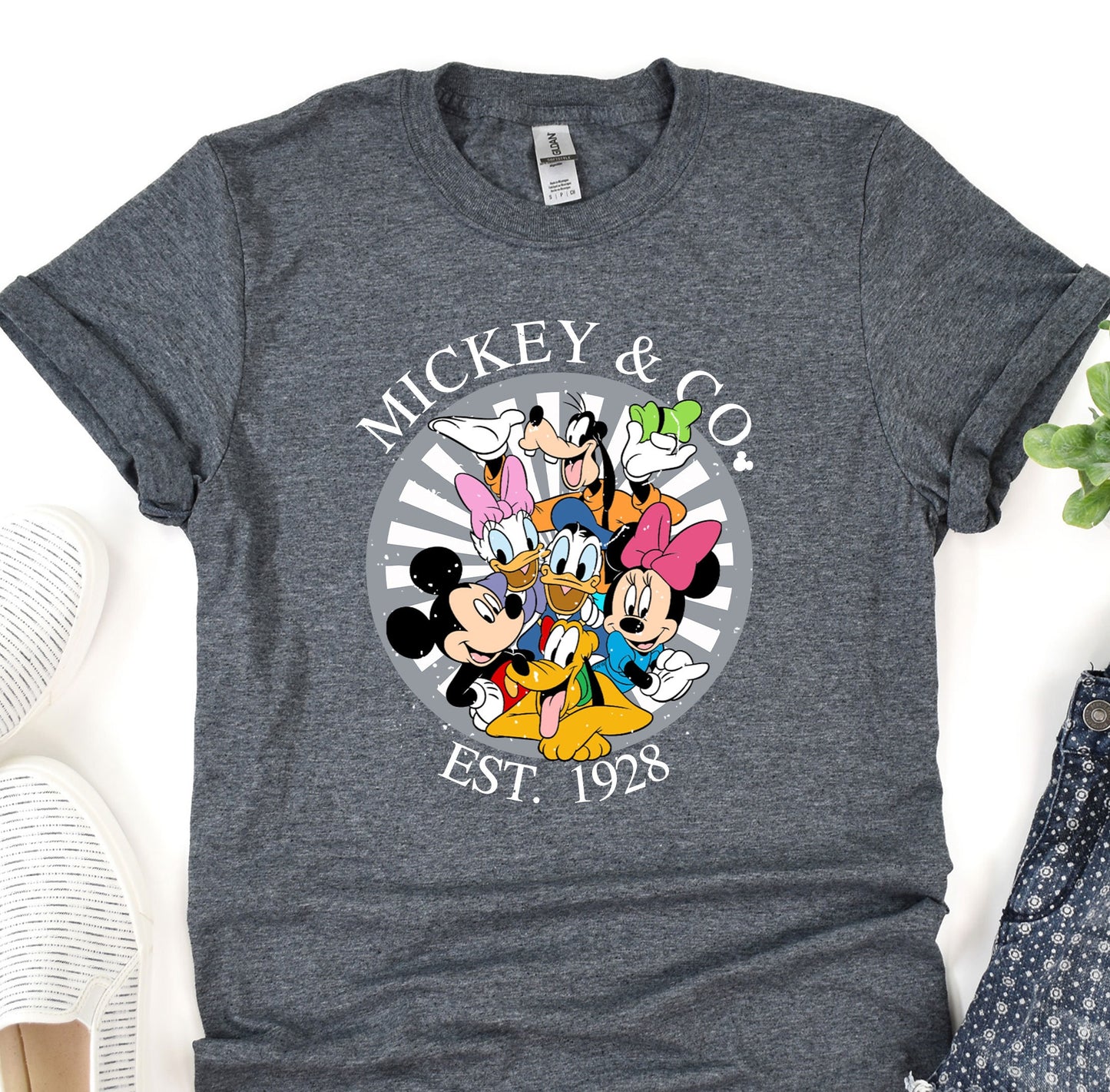 a mickey and mickey mouse shirt sitting on top of a table