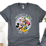 a mickey and mickey mouse shirt sitting on top of a table