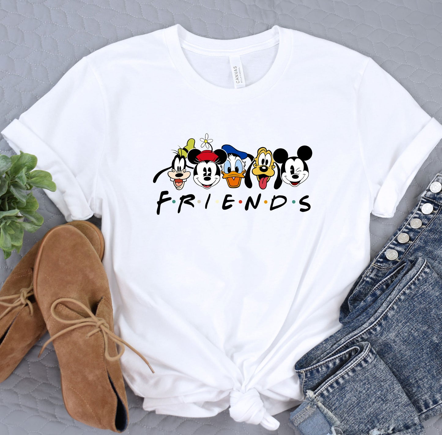 a white shirt with mickey mouse friends on it