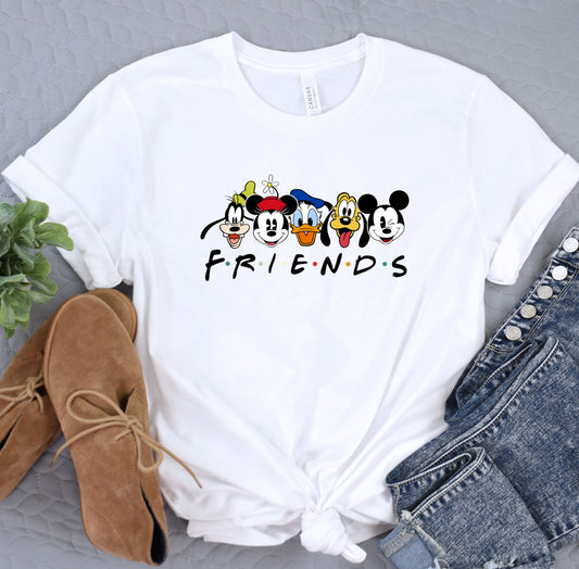 a white shirt with mickey mouse friends on it