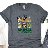 an animal kingdom t - shirt on a table next to a pair of shoes