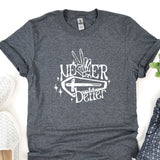 a t - shirt that says never better next to a pair of shoes