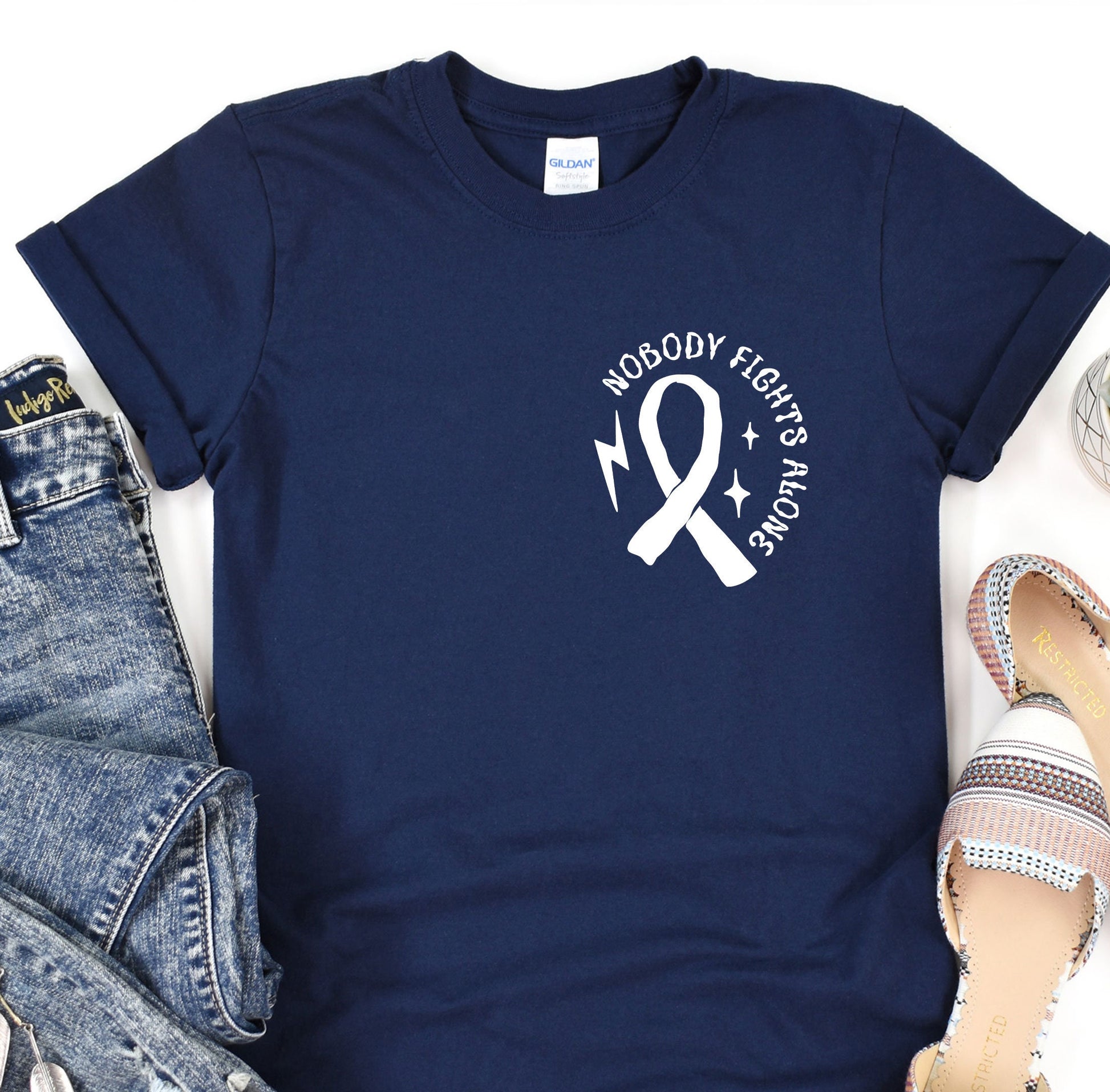 a t - shirt with a ribbon and a pair of jeans