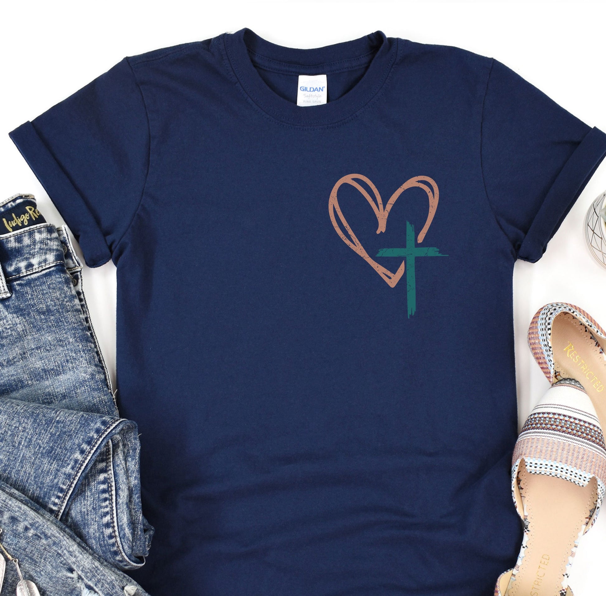 a t - shirt with a heart and a cross on it