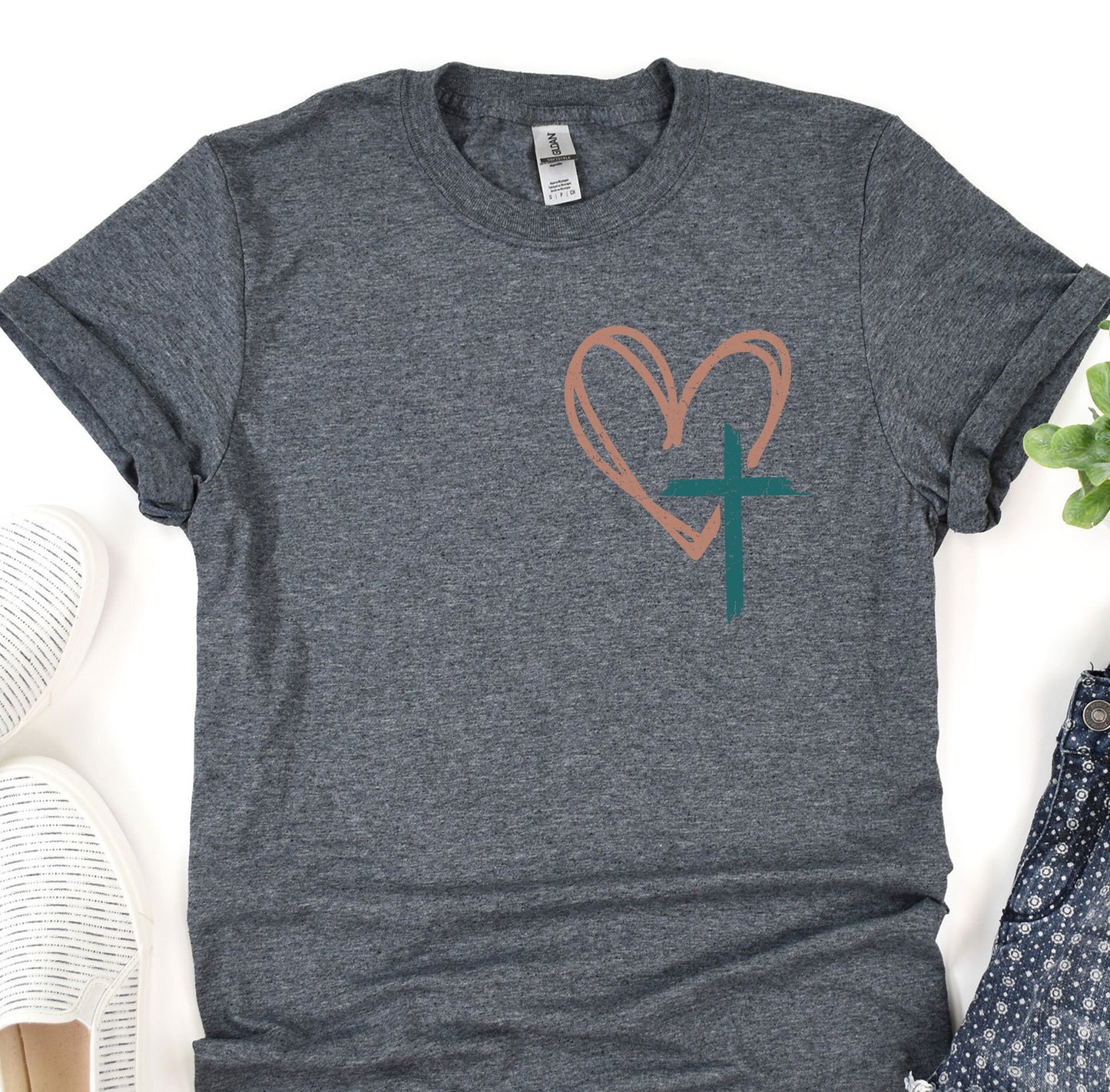 a t - shirt with a heart and a cross on it