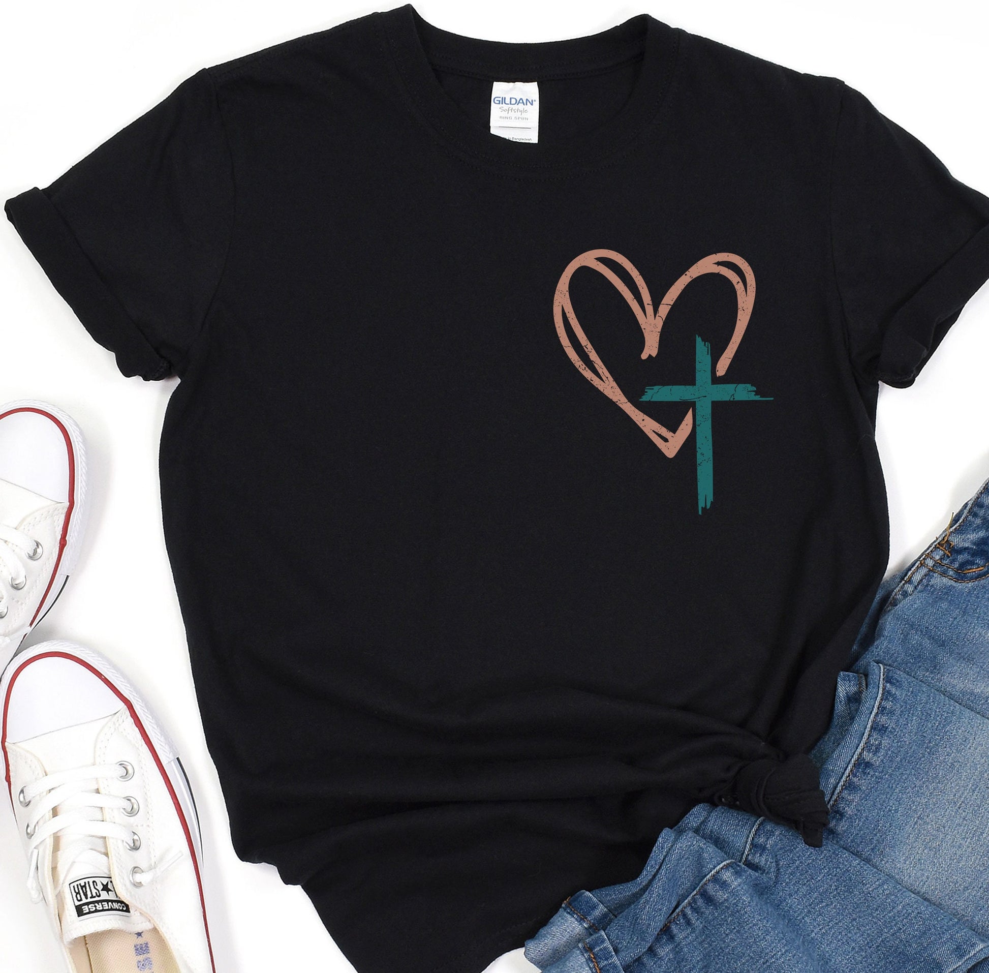 a t - shirt with a heart and a cross on it