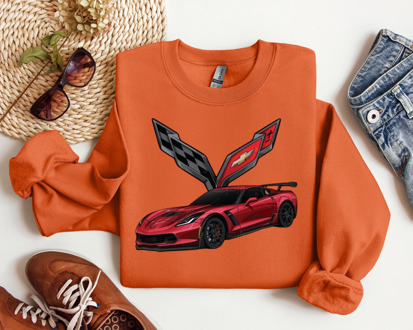 an orange sweatshirt with a red sports car on it