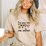 a woman wearing a t - shirt that says i'm here for the drinks