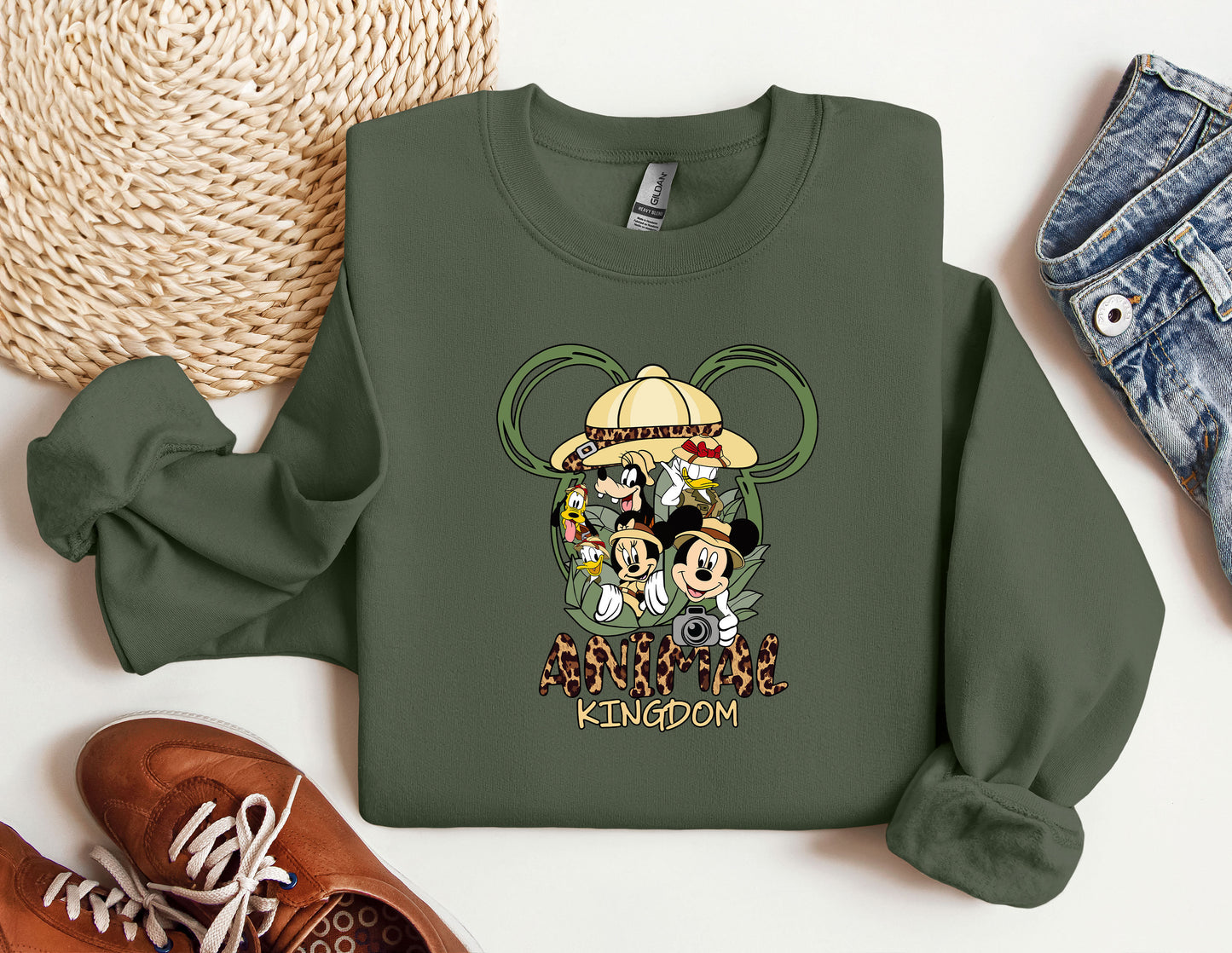 a green sweatshirt with mickey mouse and friends on it