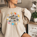 a woman wearing a sweatshirt that says drinking around the world