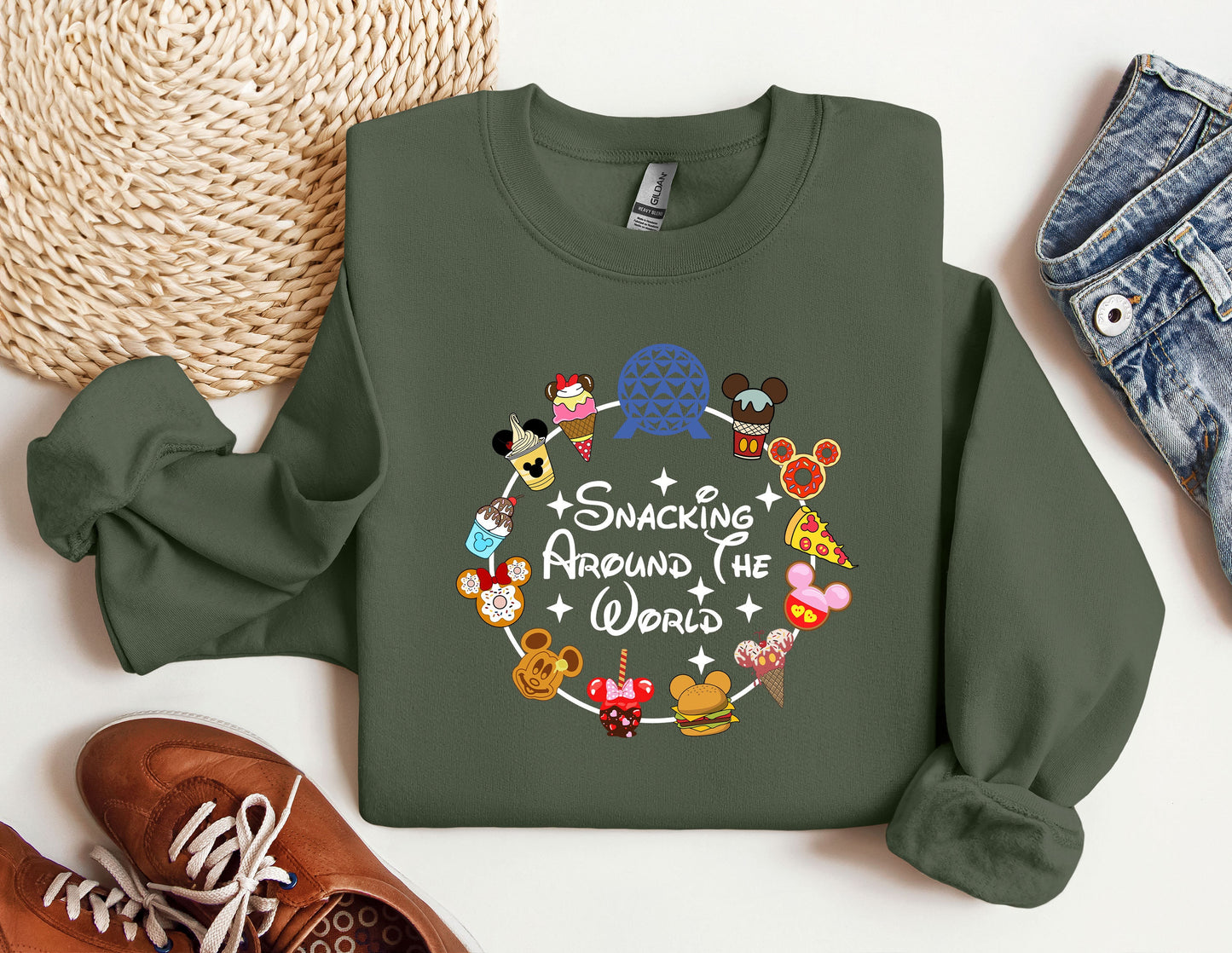 a green sweatshirt with mickey mouses around the world on it