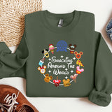a green sweatshirt with mickey mouses around the world on it