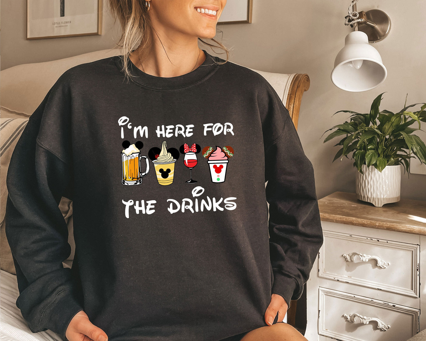 a woman wearing a sweatshirt that says i&#39;m here for the drinks