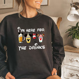 a woman wearing a sweatshirt that says i'm here for the drinks