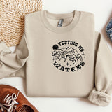 a pair of shoes, a sweater, and a pair of jeans on a white