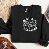 a black sweatshirt with a picture of a mountain and stars on it
