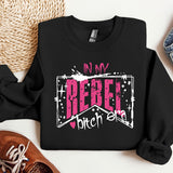 a black shirt with a pink design on it