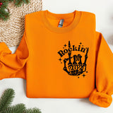 an orange sweatshirt with a rockin'in the 90's design on it