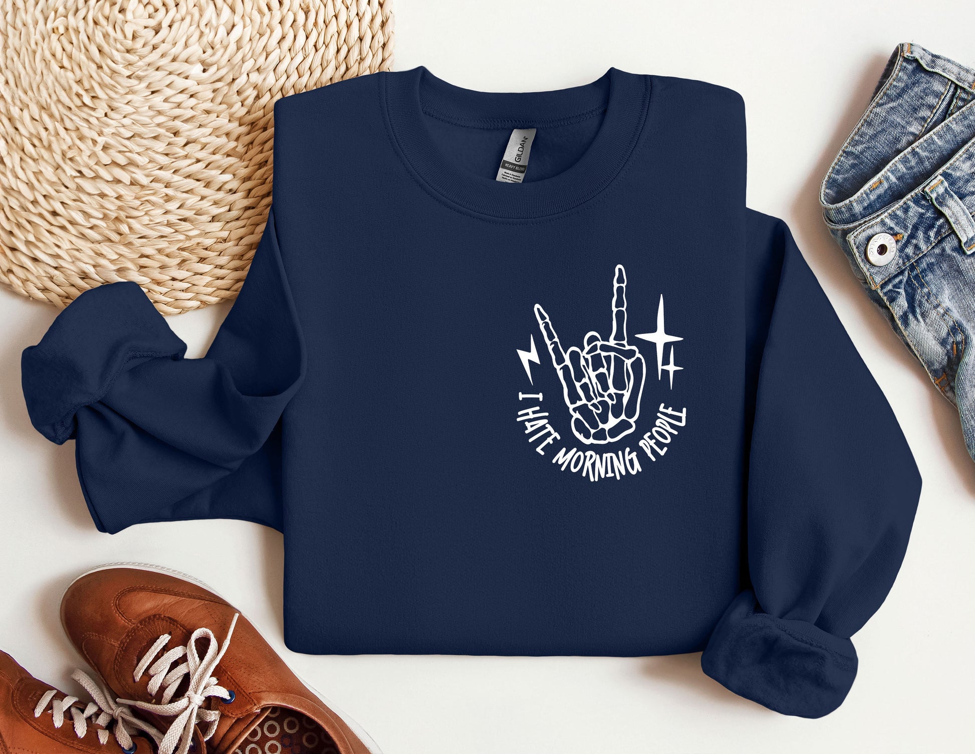 a blue sweatshirt with a white graphic of a hand holding a knife