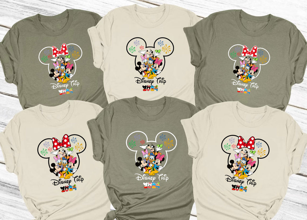 a group of mickey mouse shirts on a wooden surface