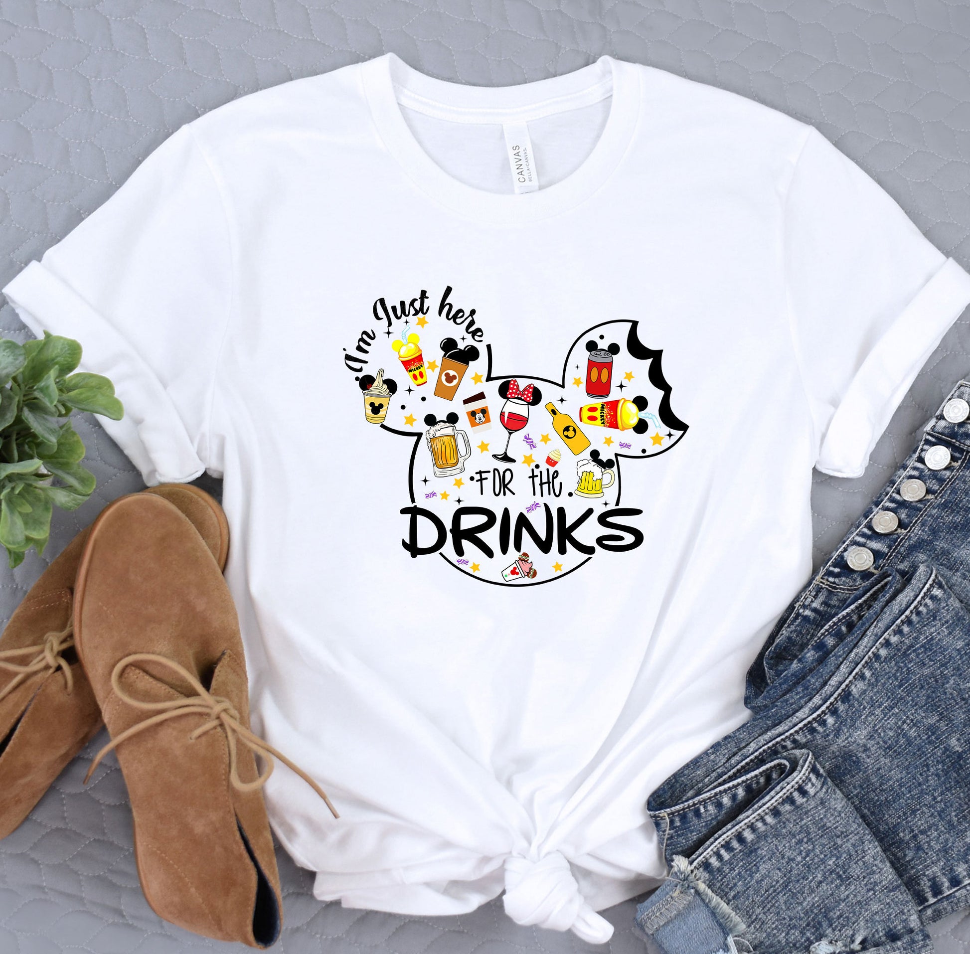 a white shirt with mickey mouse drinking wine