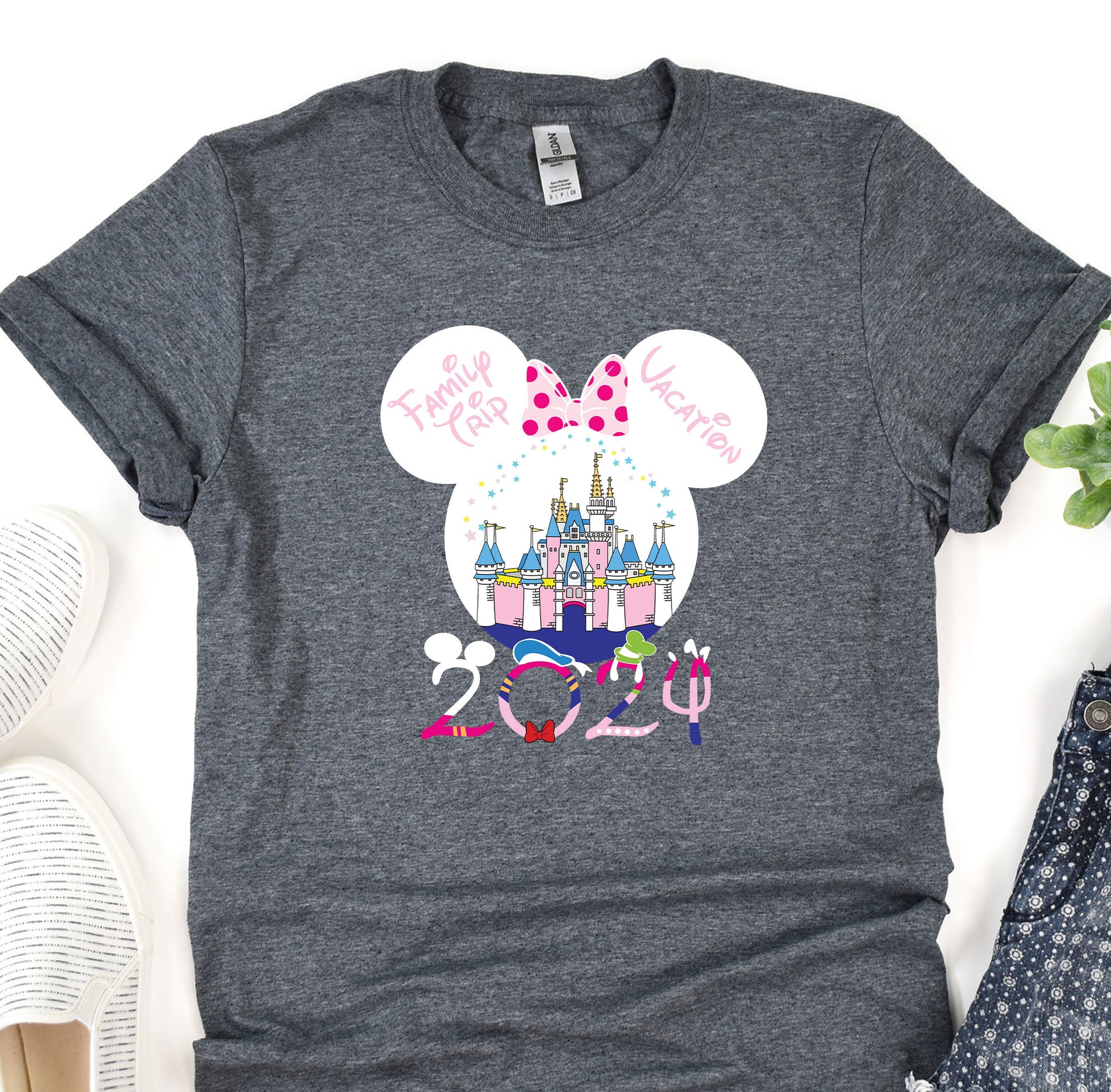 a mickey mouse shirt with a castle in the background