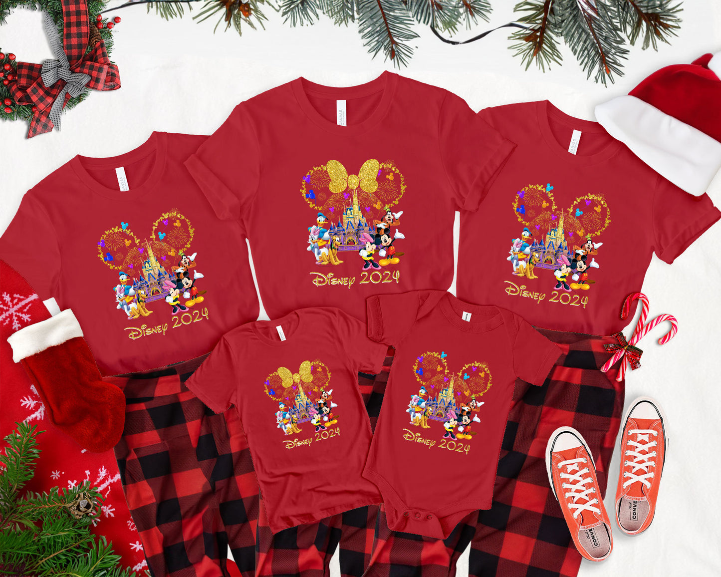 a group of mickey mouse christmas pajamas next to a christmas tree