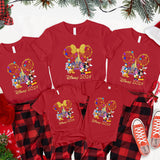a group of mickey mouse christmas pajamas next to a christmas tree