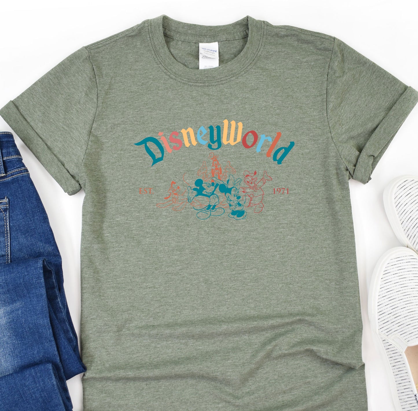 a t - shirt that says disneyland on it next to a pair of jeans