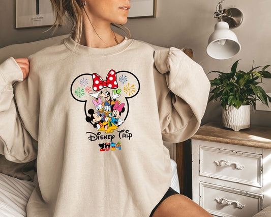 a woman wearing a sweatshirt with a mickey mouse graphic on it