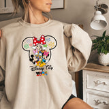 a woman wearing a sweatshirt with a mickey mouse graphic on it