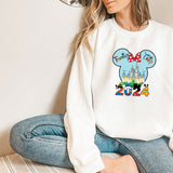 a woman sitting on the floor wearing a mickey mouse shirt