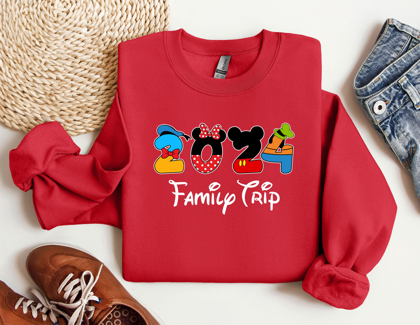 a red sweatshirt with a mickey mouse family trip on it