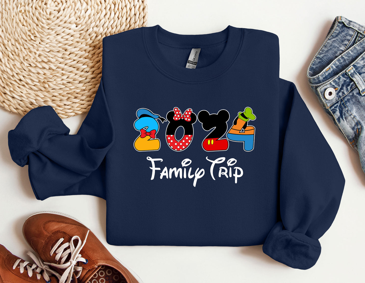 a mickey mouse family trip shirt next to a pair of sneakers