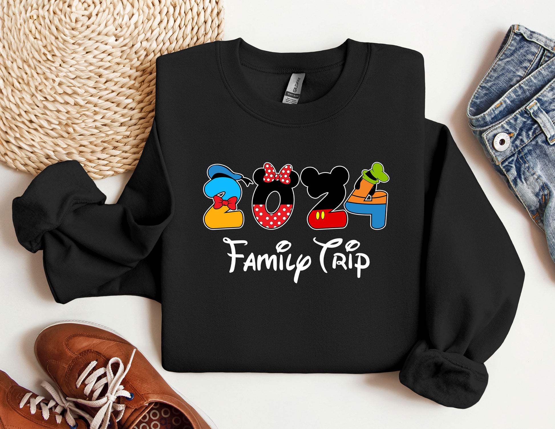 a mickey mouse family trip shirt next to a pair of sneakers