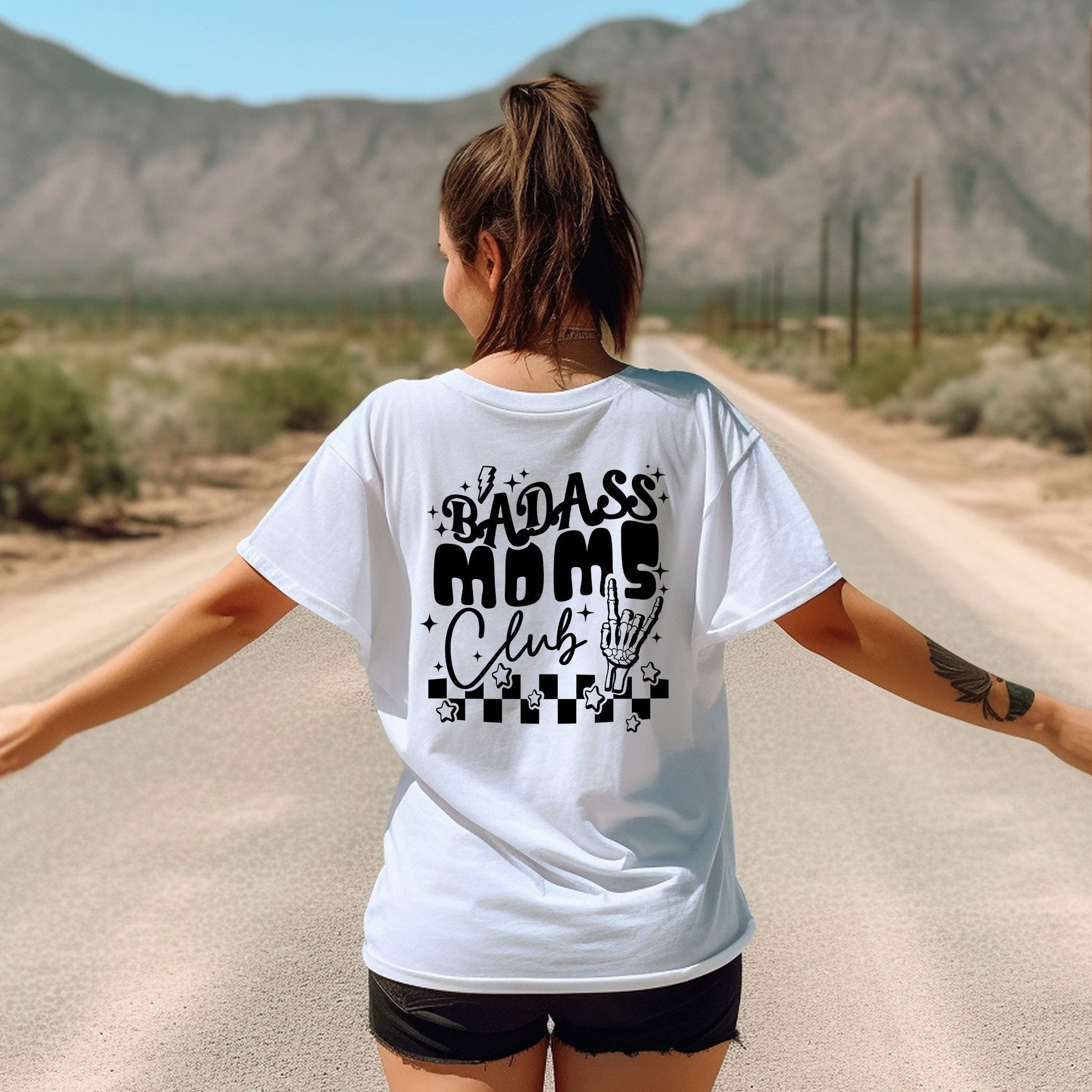 a woman walking down a road with her arms outstretched