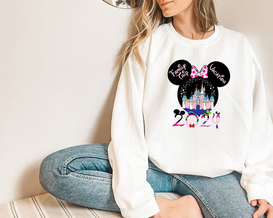 a woman sitting on the floor wearing a mickey mouse shirt