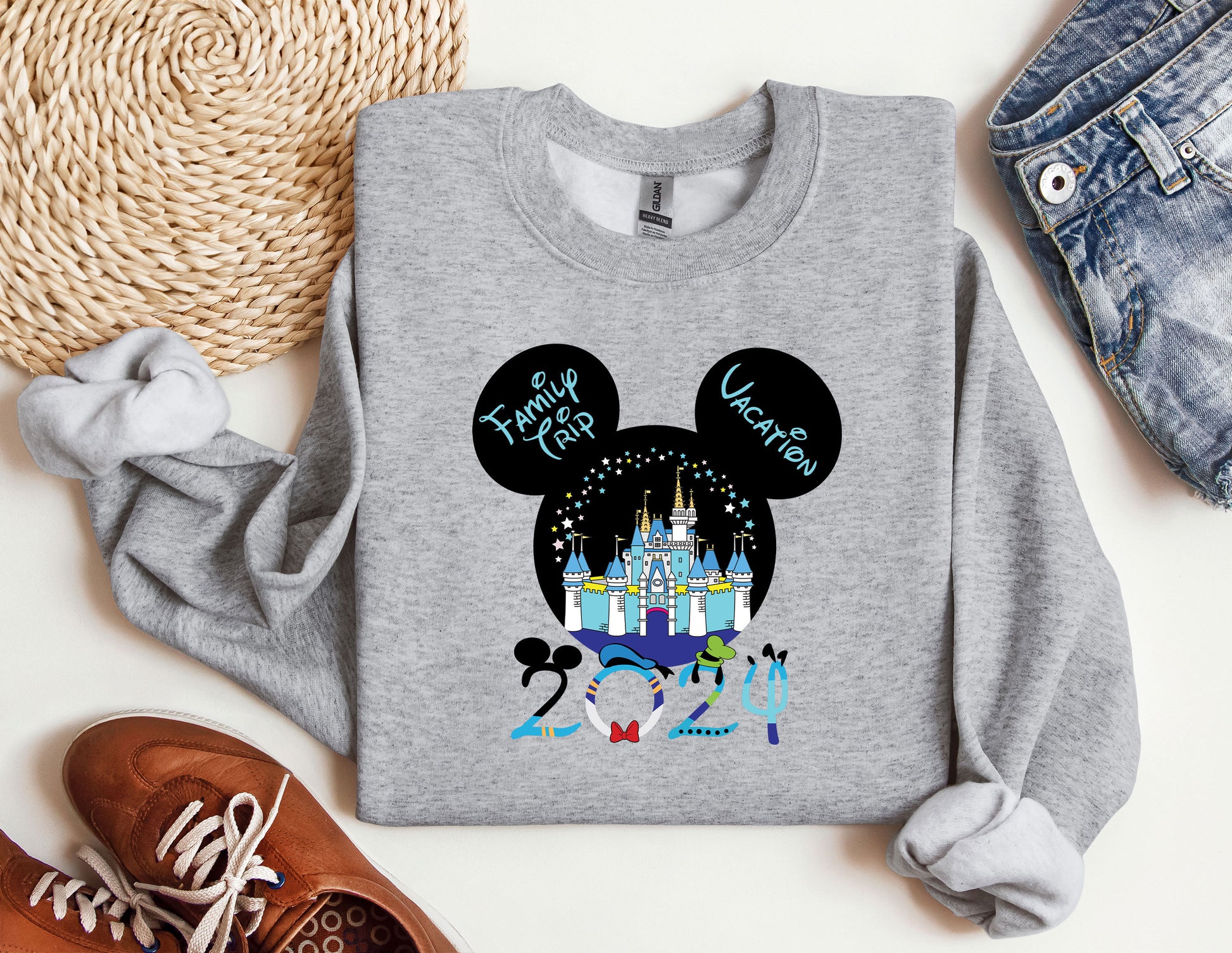 a mickey mouse shirt with a castle in the background