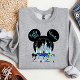 a mickey mouse shirt with a castle in the background