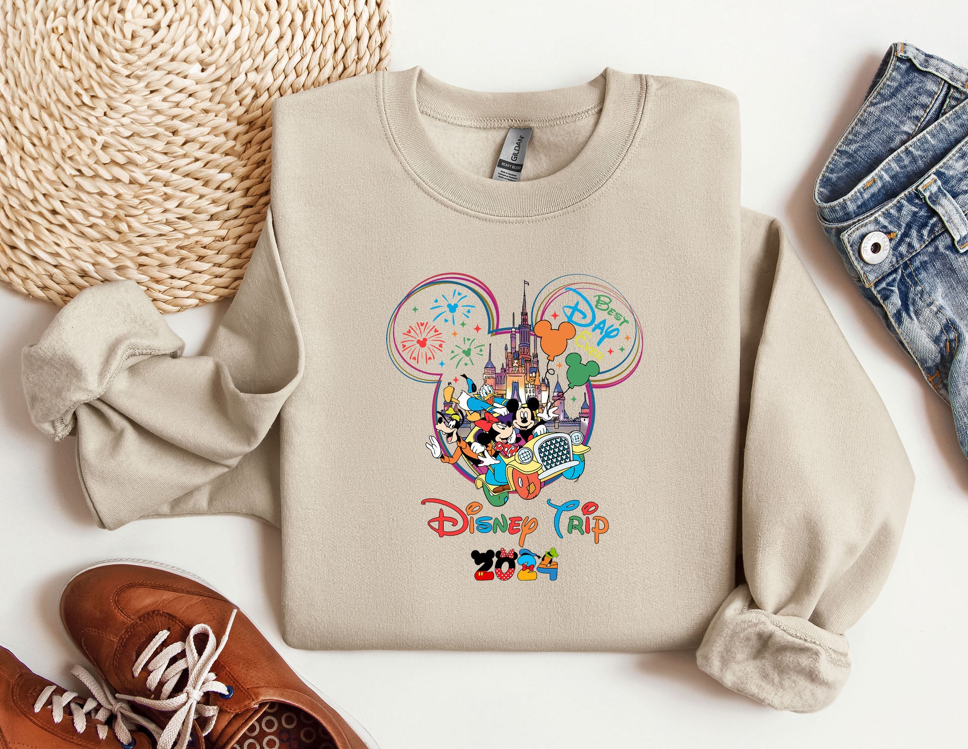 a mickey mouse sweatshirt with a pair of shoes next to it