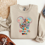 a mickey mouse sweatshirt with a pair of shoes next to it