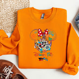 an orange shirt with mickey mouse on it