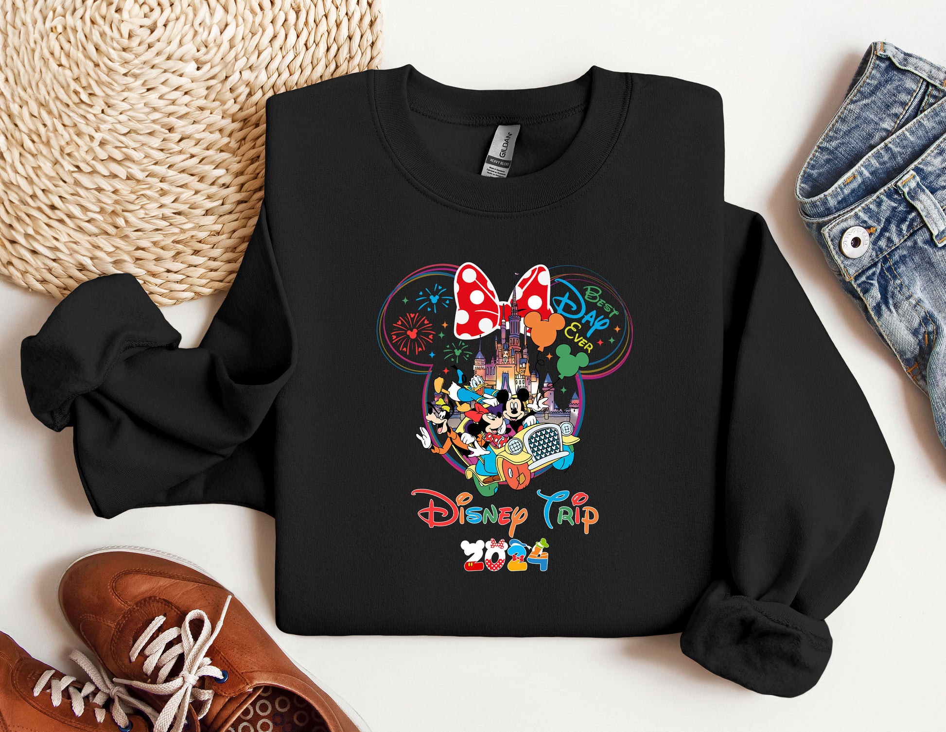 a mickey mouse shirt and some shoes on a table