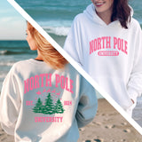 two women in sweatshirts standing on the beach