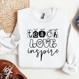 a white sweatshirt with the words teach love inspire on it